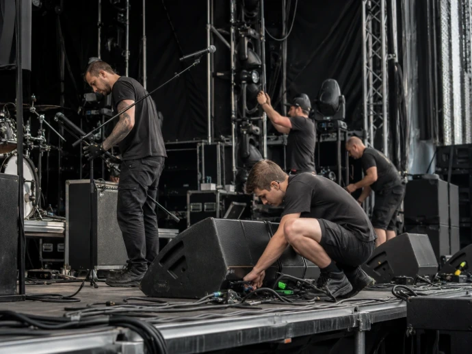 Stage technicians during equipment preparation and concert stage setup